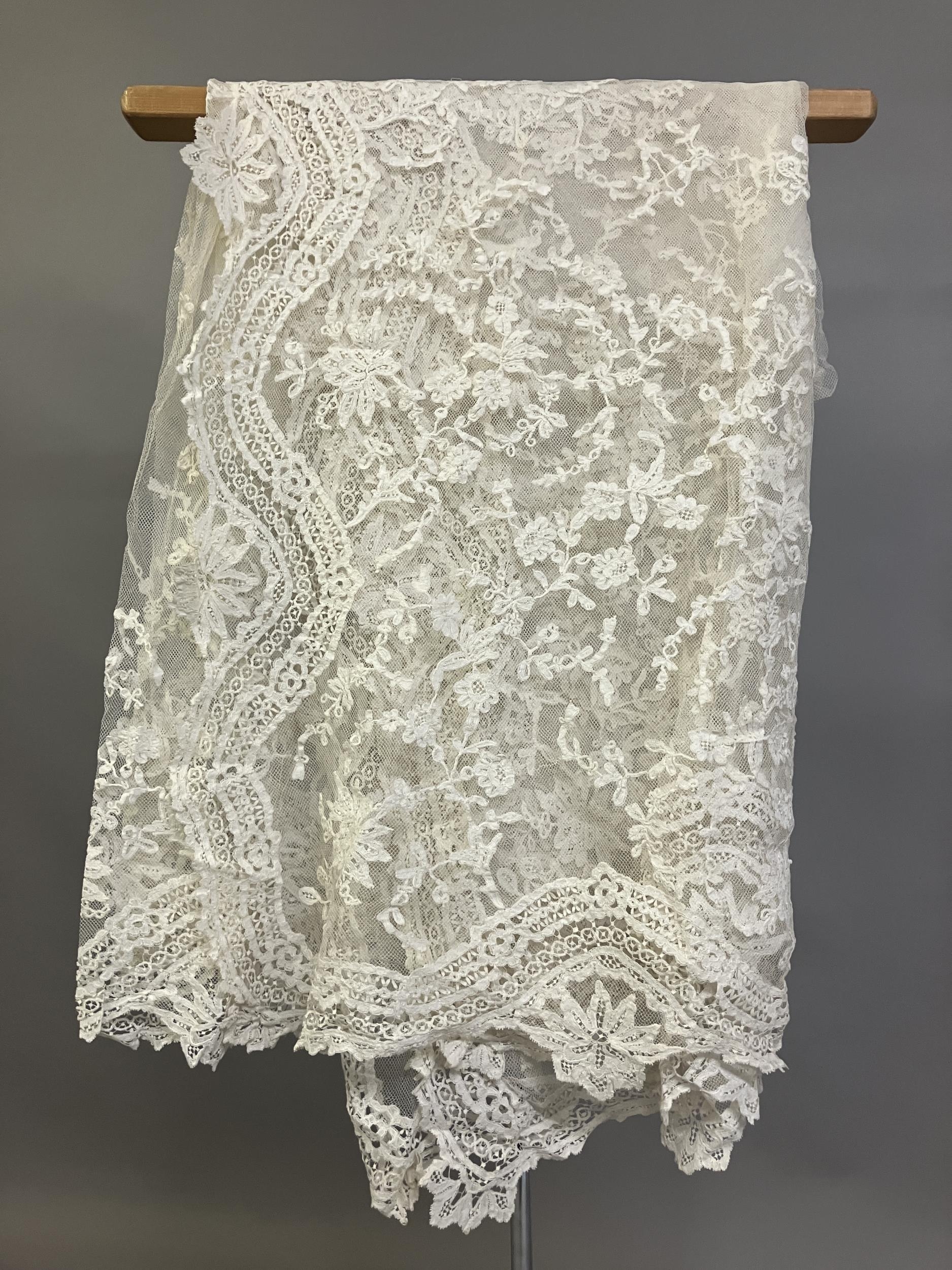 Antique Lace: an elaborate late 19th century Honiton lace wedding veil, the net densely applied with