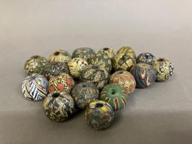 Trade beads: a selection of intricately pattered, medium round beads in mainly subtle colours (