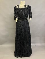 An extravagant sequined and beaded evening ensemble of skirt and bodice, black, the bodice of net