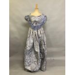 C 1855, a pale lilac silk brocade bodice and skirt ensemble, with a woven design of flowers and