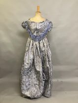 C 1855, a pale lilac silk brocade bodice and skirt ensemble, with a woven design of flowers and