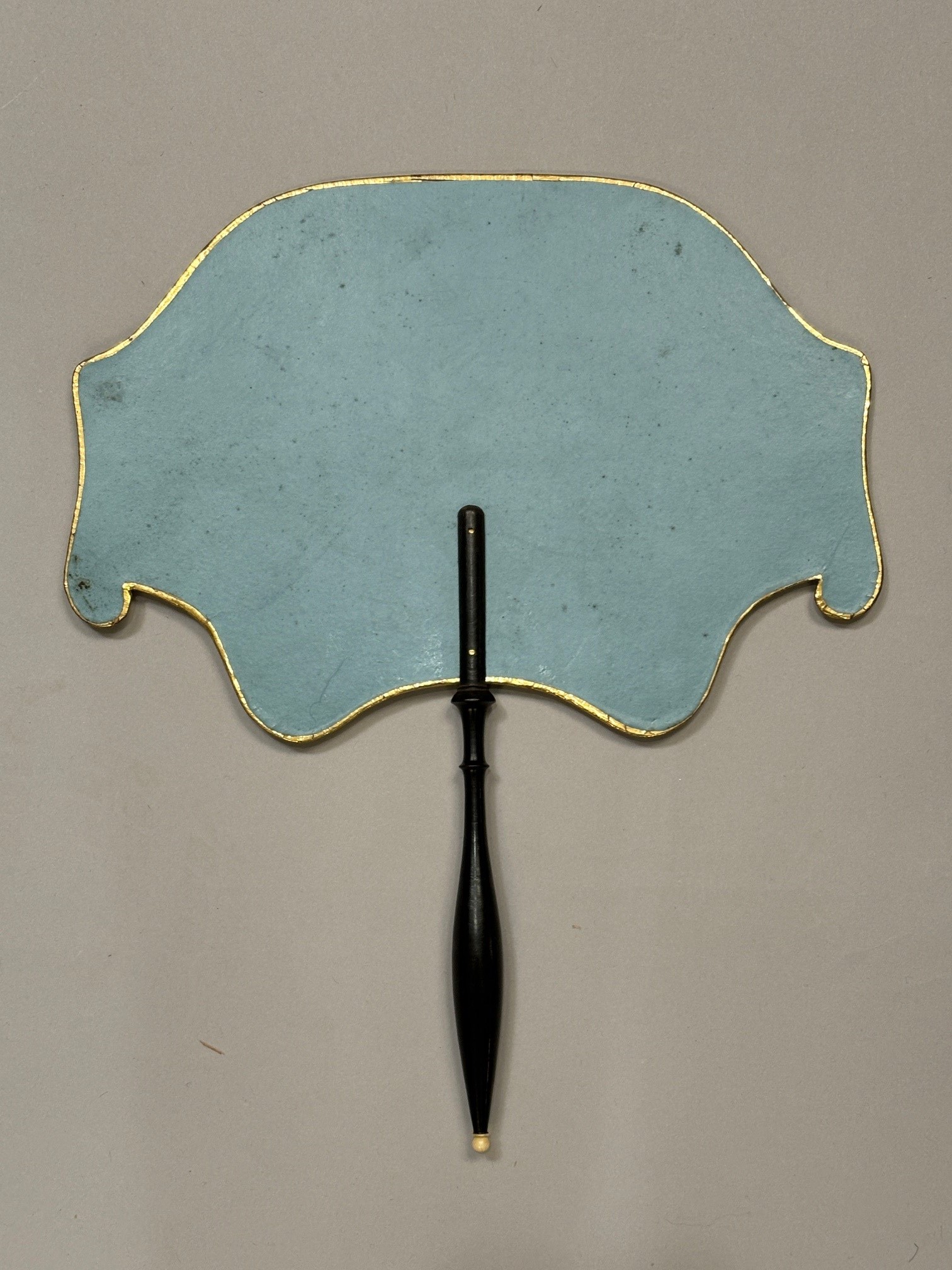 A good regency fixed fan, shaped, the recto applied with gold foil and a gravure showing a mother - Image 2 of 3