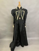 A c 1890’s/900 black silk two-piece ensemble, the tailored bodice with gathers to the shoulder and