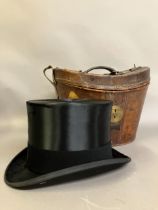 A leather top hat case lined in purple velvet, and silk top hat by Lock and Co. (hat + case) (