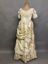 An elaborate 1880’s wedding or evening gown, skirt with integral boned bodice, a heavy honey silk,