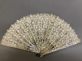 Antique Lace: an early 20th century Maltese silk lace fan, the leaf mounted on pink mother of