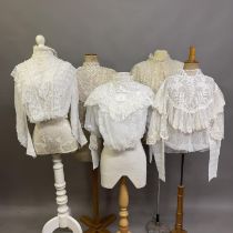 Two Edwardian blouses, the first white, high-necked, full sleeves, incorporating floral machine