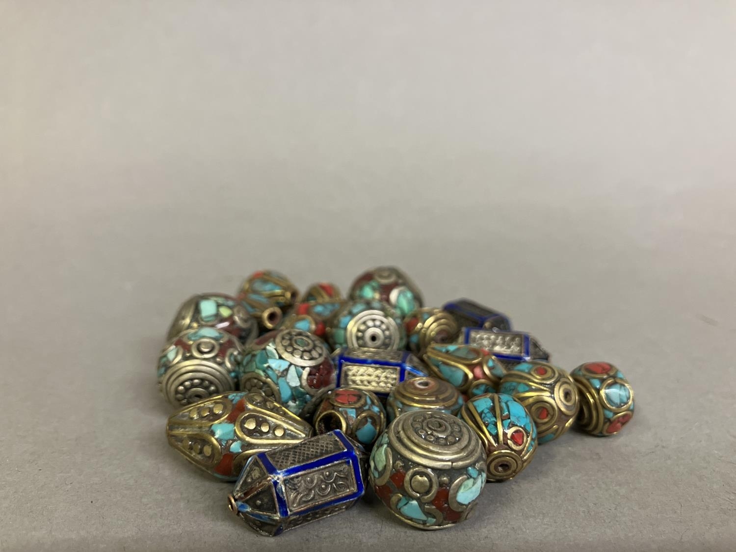 Trade beads: a selection of small beads with metal inlay, four similar in royal blue, the