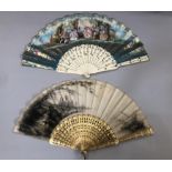 Two mid-19th century fans, the first with carved and pierced wood sticks, painted in gold, the cream