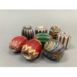 Trade beads: six large chevron beads and two others, in varying colours, average length approx. 3.