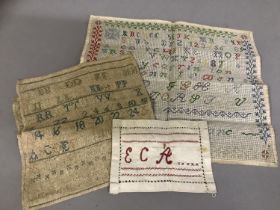 An antique linen band sampler, alpha/numeric, dated 1834; together with a colourful alpha/numeric
