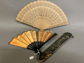A 19th century Chinese fan case or sleeve, navy blue silk embroidered with auspicious symbols, edged