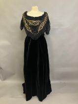 A mid-19th century black velvet evening two piece, the full skirt plain, the bodice rear-lacing,