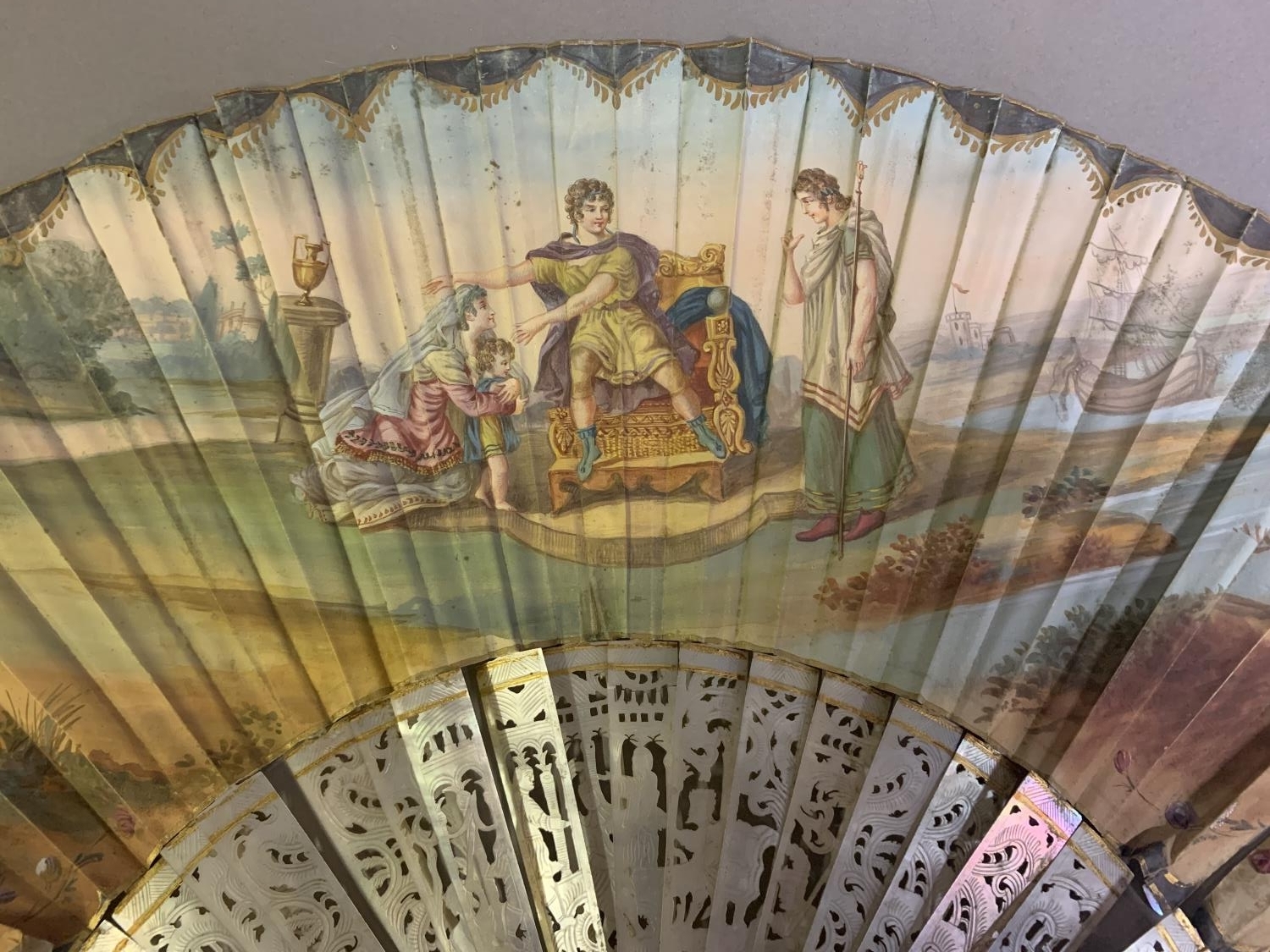 An 18th century mother of pearl fan with leaf of painted silk, showing a man seated on a throne, a - Image 2 of 9