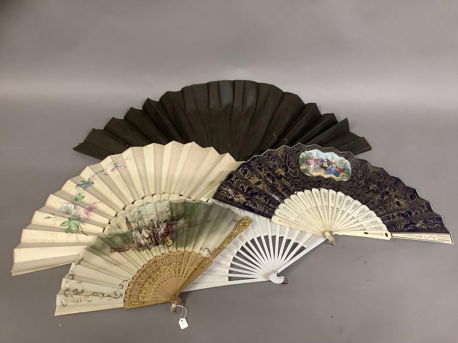 A varied selection of 19th and 20th century fans, comprising a very large example with black wood