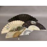A varied selection of 19th and 20th century fans, comprising a very large example with black wood