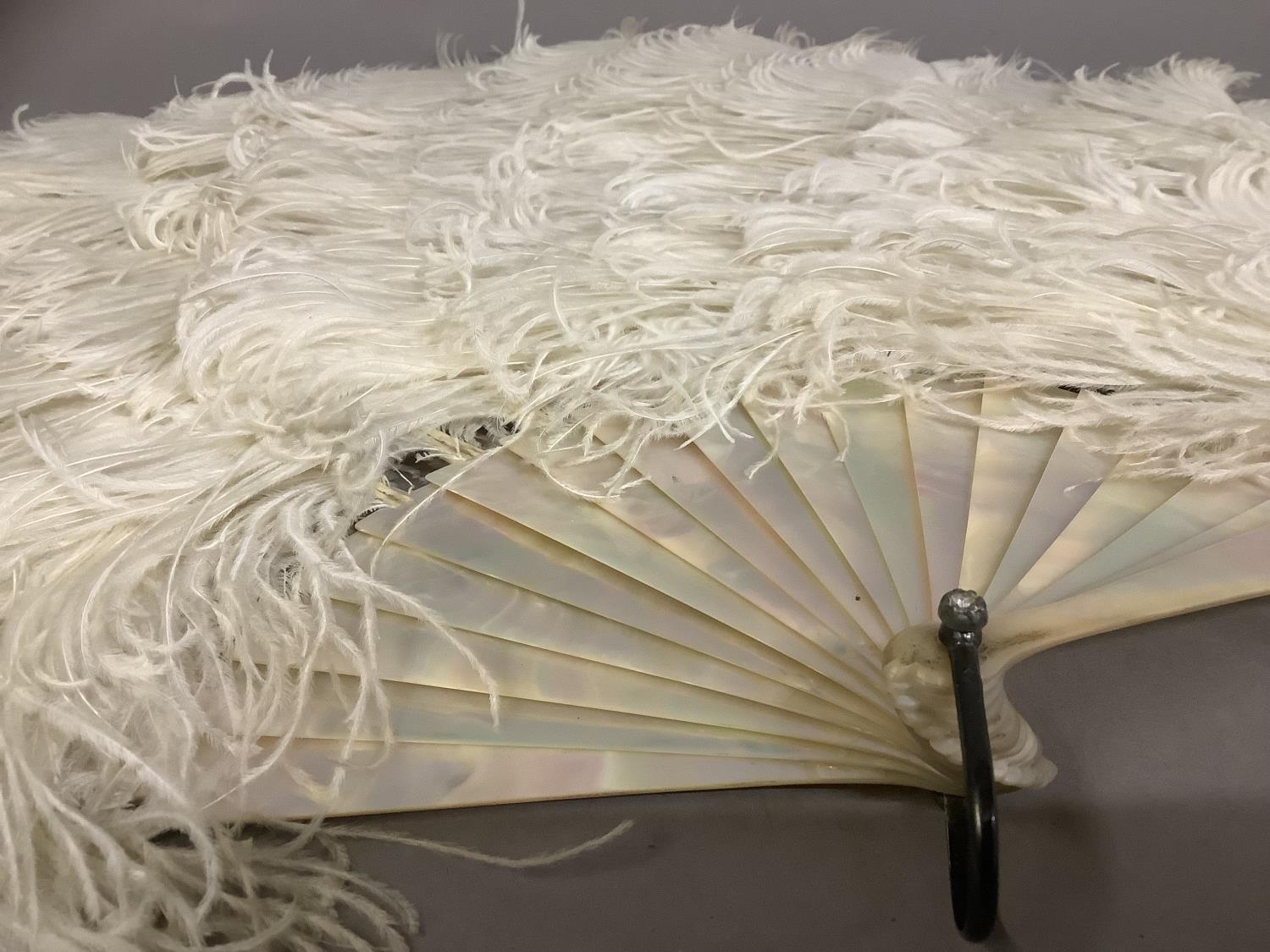 A late 19th century white ostrich feather fan, the monture of pink/green burgau mother of pearl, - Image 3 of 6