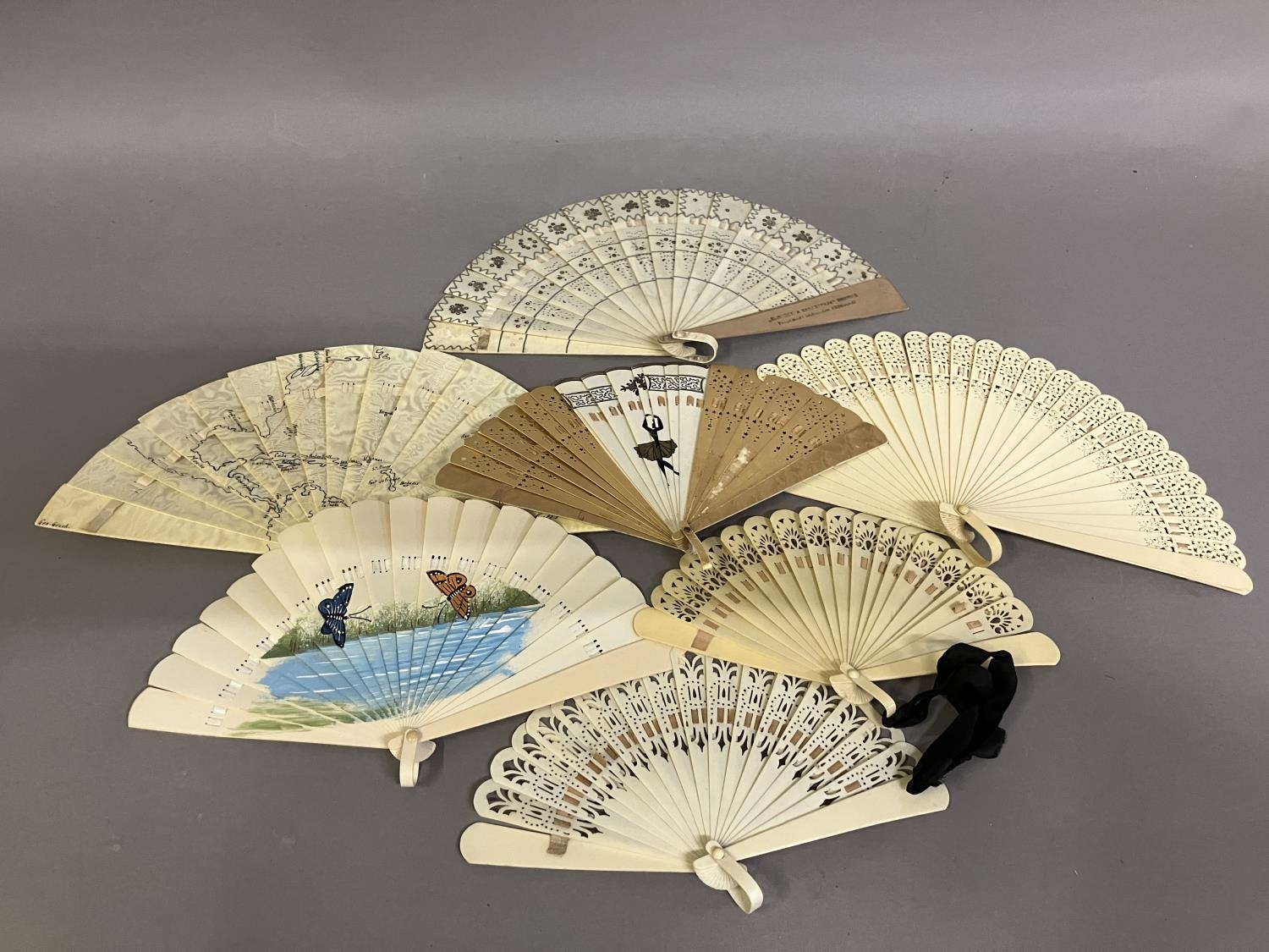 A selection of small brisé fans: a brisé fan advertising Victoria Luise, a shield on the lower guard