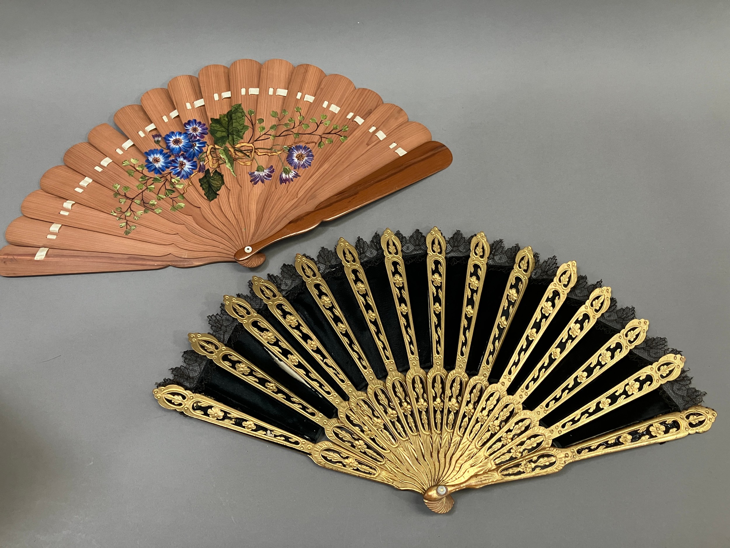 A wood fan, the monture carved and pierced, painted gold, c 1870’s, the black silk satin leaf with