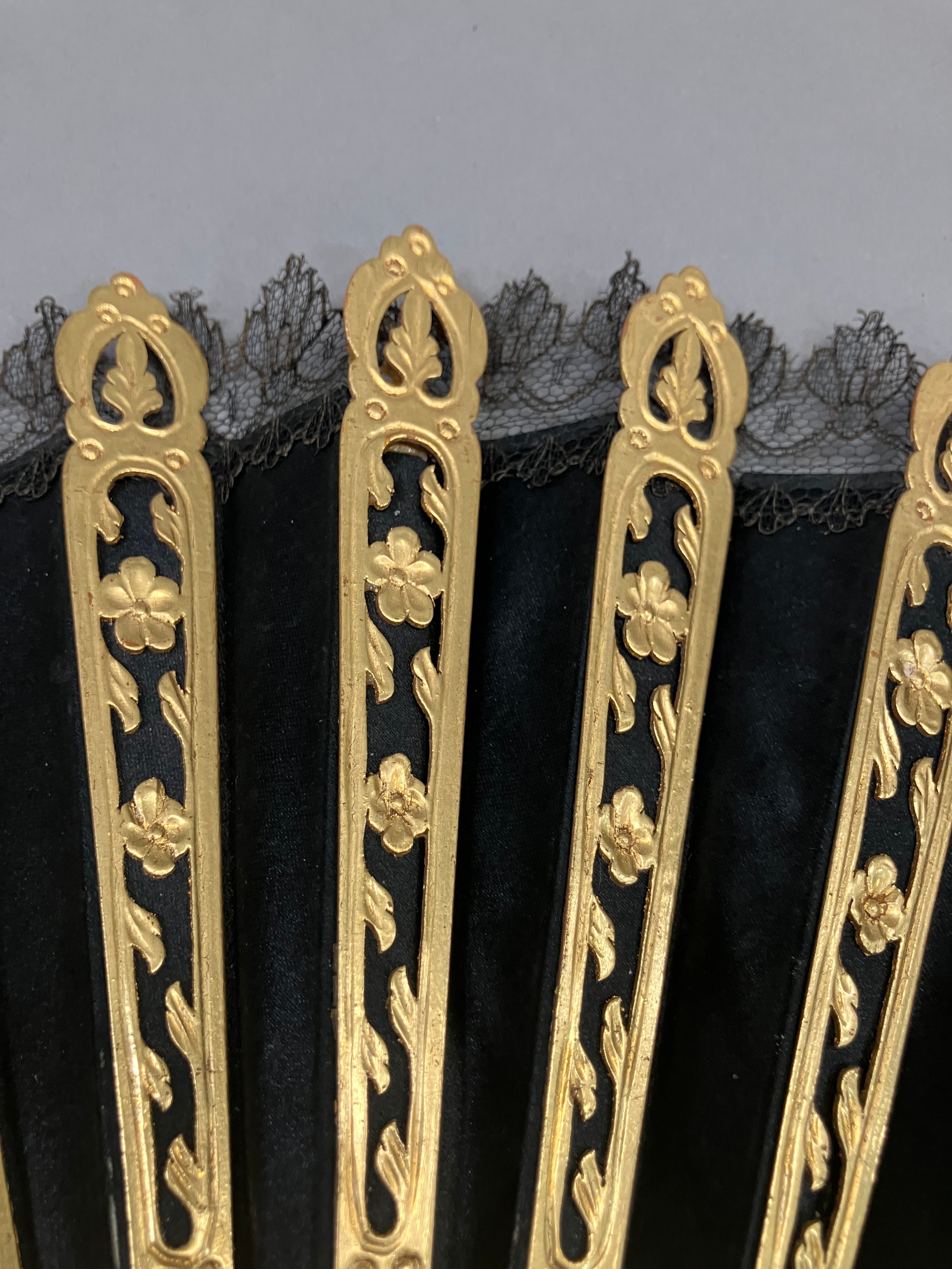 A wood fan, the monture carved and pierced, painted gold, c 1870’s, the black silk satin leaf with - Image 3 of 5