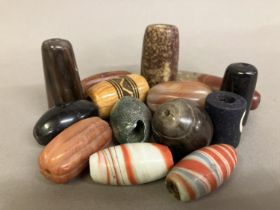 Trade beads: a selection of large beads, with three in segmented form, the largest shaded and