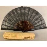 A 19th century tortoiseshell fan mounted with a black Chantilly bobbin lace leaf, the design of