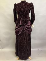 An 1880’s cut velvet two piece in ruby, the tailored jacket boned and lined in patterned cotton, the