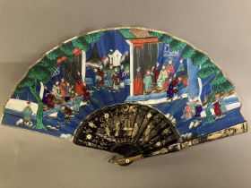 A Chinese Mandarin fan of uncommon medium size, the monture wood, lacquered in black, painted in