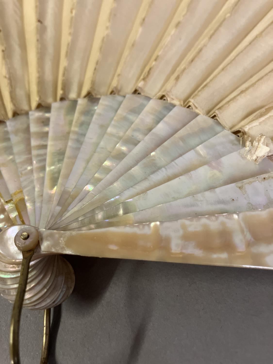 A large fan, the monture of pink mother of pearl, gilded, the cream silk leaf Chinese, being - Image 8 of 8