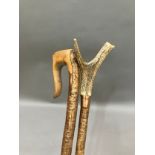 Two walking sticks, one with antler handle the other with crook handle