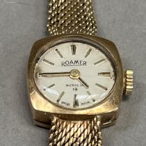 A Roamer lady's manual wrist watch in 9ct gold, cushion case on an integral Milanese bracelet,