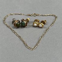 A pair of early to mid 20th century jade ear studs in 9ct gold each set with a circular nephrite