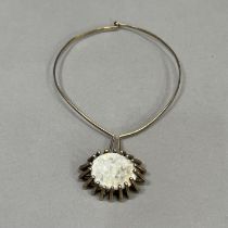 A silver quartz geode pendant c1965, the oval convex crystaline stone claw set pendant from a torq