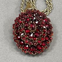 A 19th century Bohemian garnet cluster pendant/locket of oval outline all over set to the front