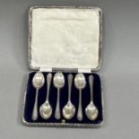 A boxed set of six silver golf spoons, Sheffield 1933 for Walker and Hall, approximate weight 2.5oz