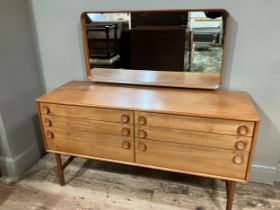 A 1960/70s Merrydew teak dressing table having a framed rectangular mirror over two banks of three