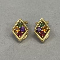 A pair of cluster ear clips, each claw set with circular faceted amethyst, garnet, citrean and