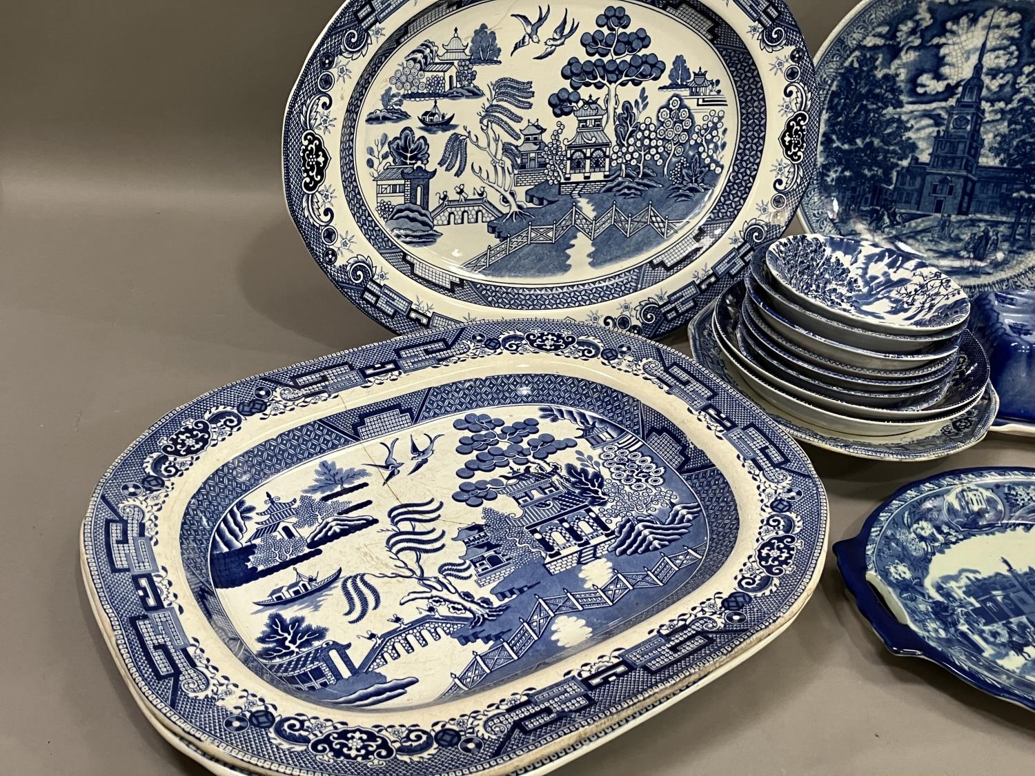 A collection of blue and white ware including 19th century willow pattern plates, later wild rose - Image 2 of 3