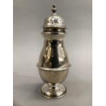 A silver castor of baluster form, 20cm high, approximate weight 6.5oz, London 1913