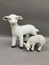 A ceramic figure of a lamb together with a smaller composite example