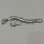 An early to mid 20th century centipede brooch (at fault) in .800 silver in full relief, set to the