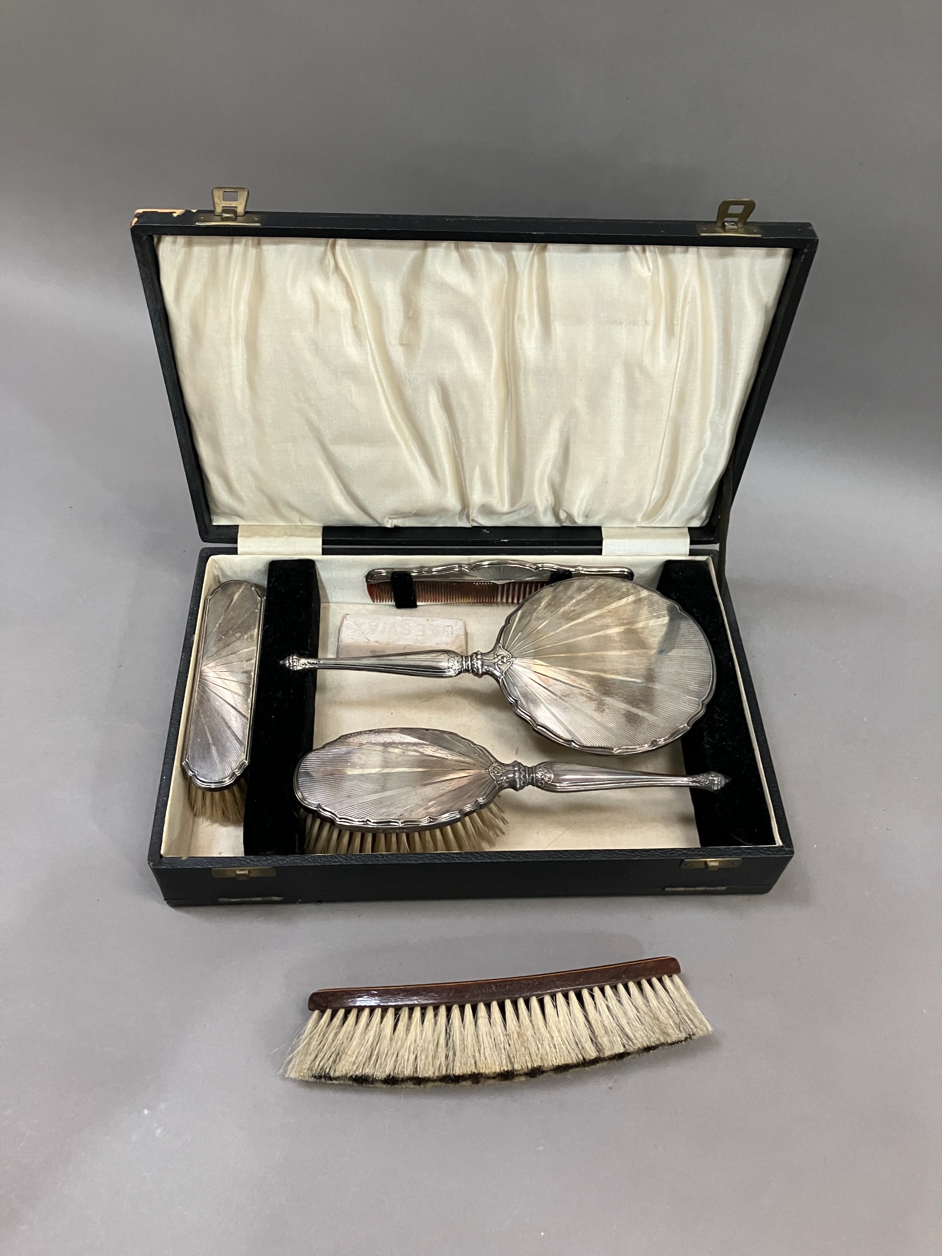 Four piece silver backed dressing table set, Birmingham 1932 in fitted case, comprising hand mirror,