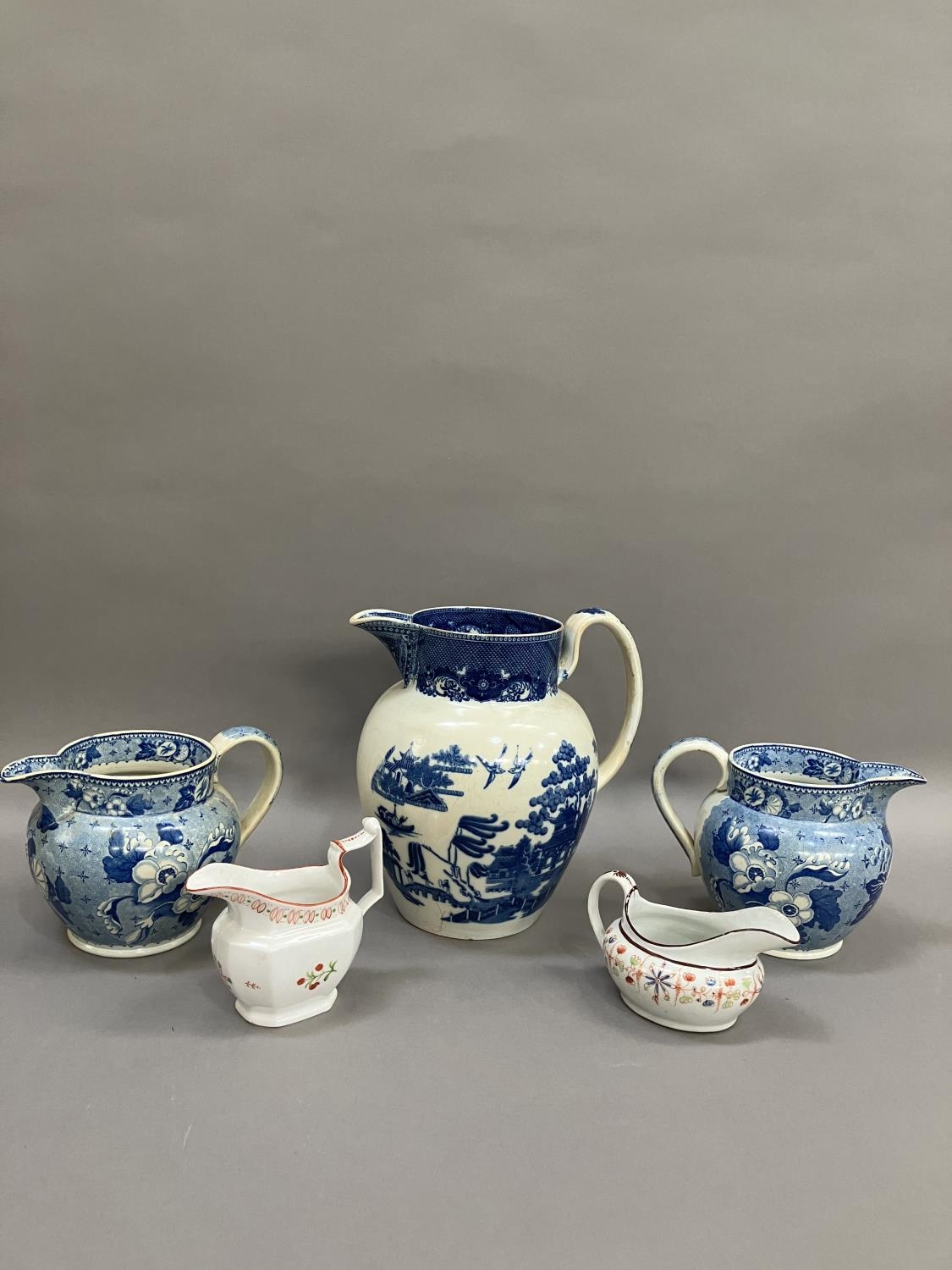 A pair of 19th century blue and white transfer printed jugs of floral pattern, 14cm over handle - Image 2 of 7