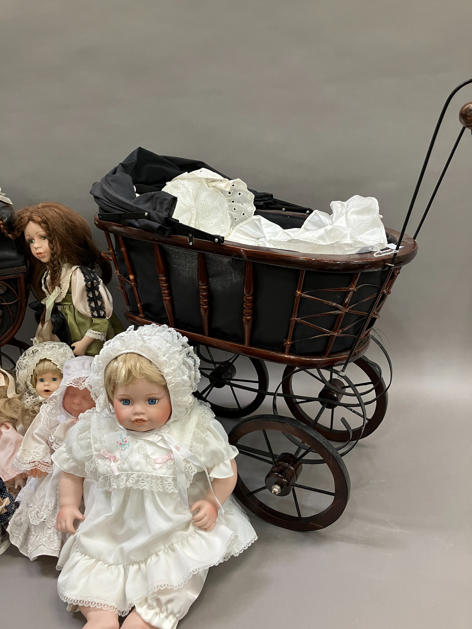 A collection of six modern porcelain dolls in costume, together with two Victorian style prams - Image 4 of 4