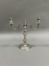 An 18th century style silver two light candelabra with c-scroll arms and on a knopped column with