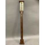 An oak barometer/thermometer by Comitti and Son Ltd London, 20th century, 92cm long