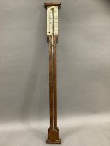 An oak barometer/thermometer by Comitti and Son Ltd London, 20th century, 92cm long
