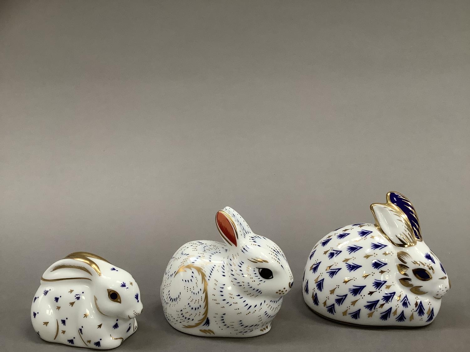 Three Royal Crown Derby paperweight rabbits including a bunny, exclusive for A Royal Crown Derby