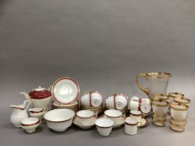 A Minton china tea service bordered in pink and gilt comprising teapot, sugar and milk, eleven cups,