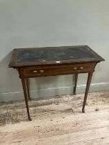 An Edwardian mahogany and satinwood banded writing table having a Rexine incised writing surface